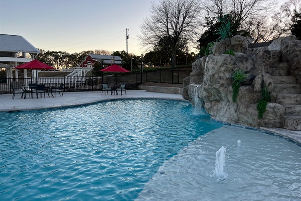Resort style 30,000-gallon saltwater pool with double waterfalls and grotto and slide