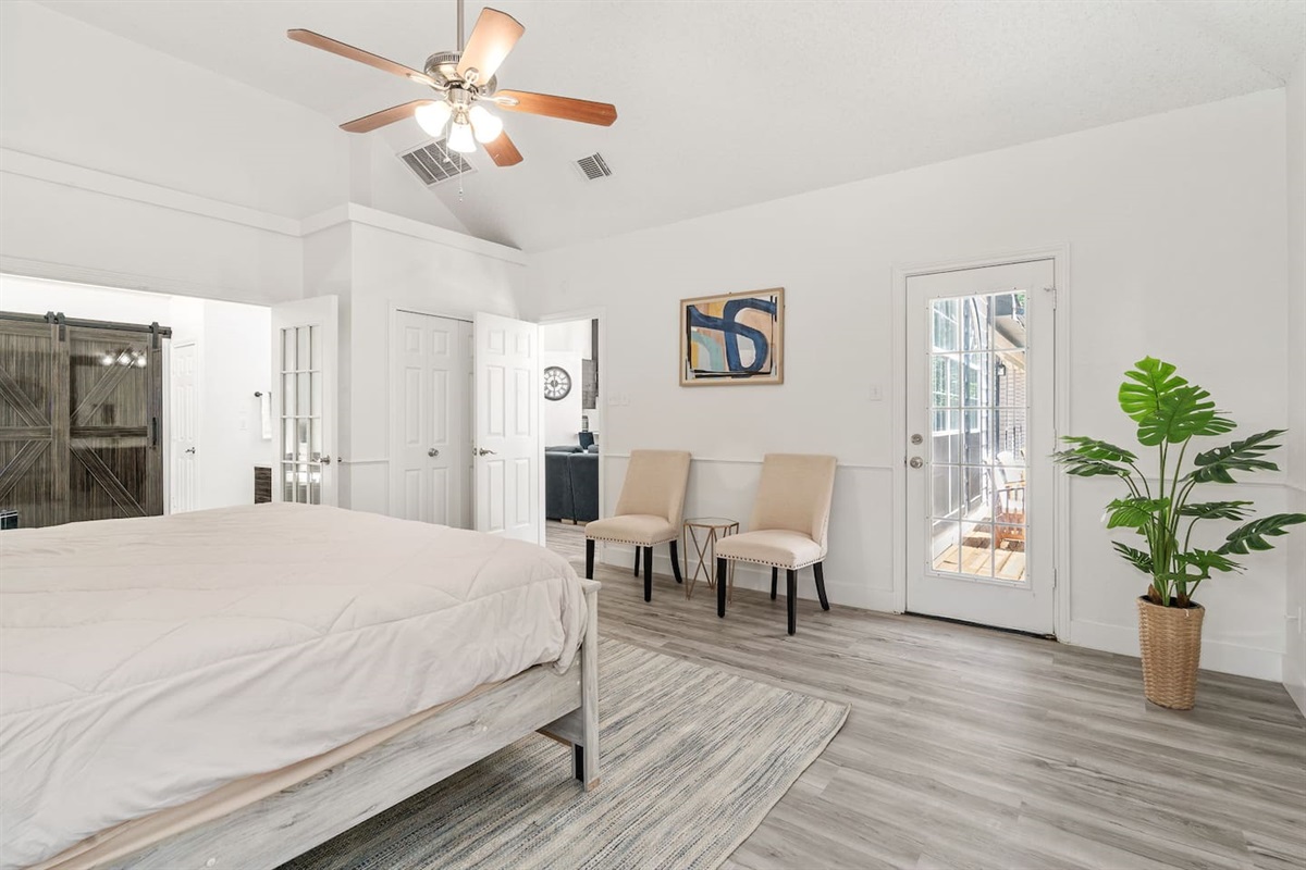 Comfortable Master bedroom with modern decor, sitting area, and plush bedding.