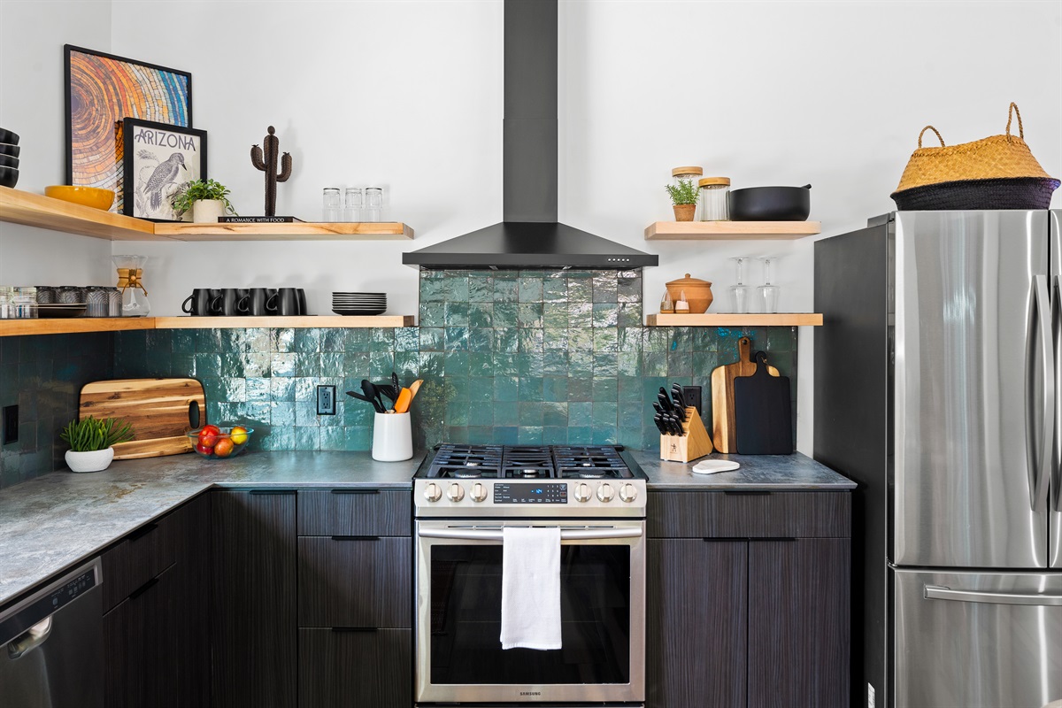 Modern kitchen with stainless steel appliances, open shelving, and a sleek design for cooking and entertaining.