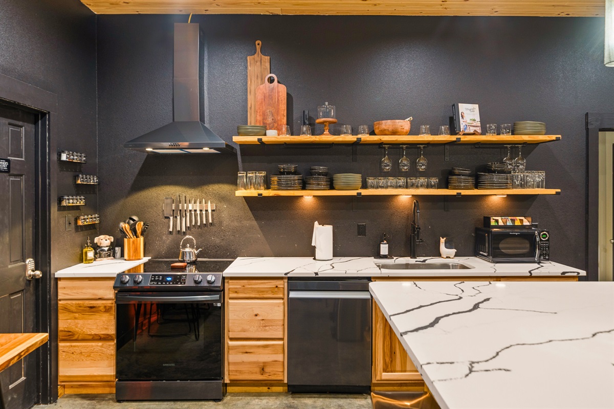 Open shelving and sleek finishes give this kitchen a modern edge, while still feeling cozy and functional for everything from pancake breakfasts to late-night snacks.