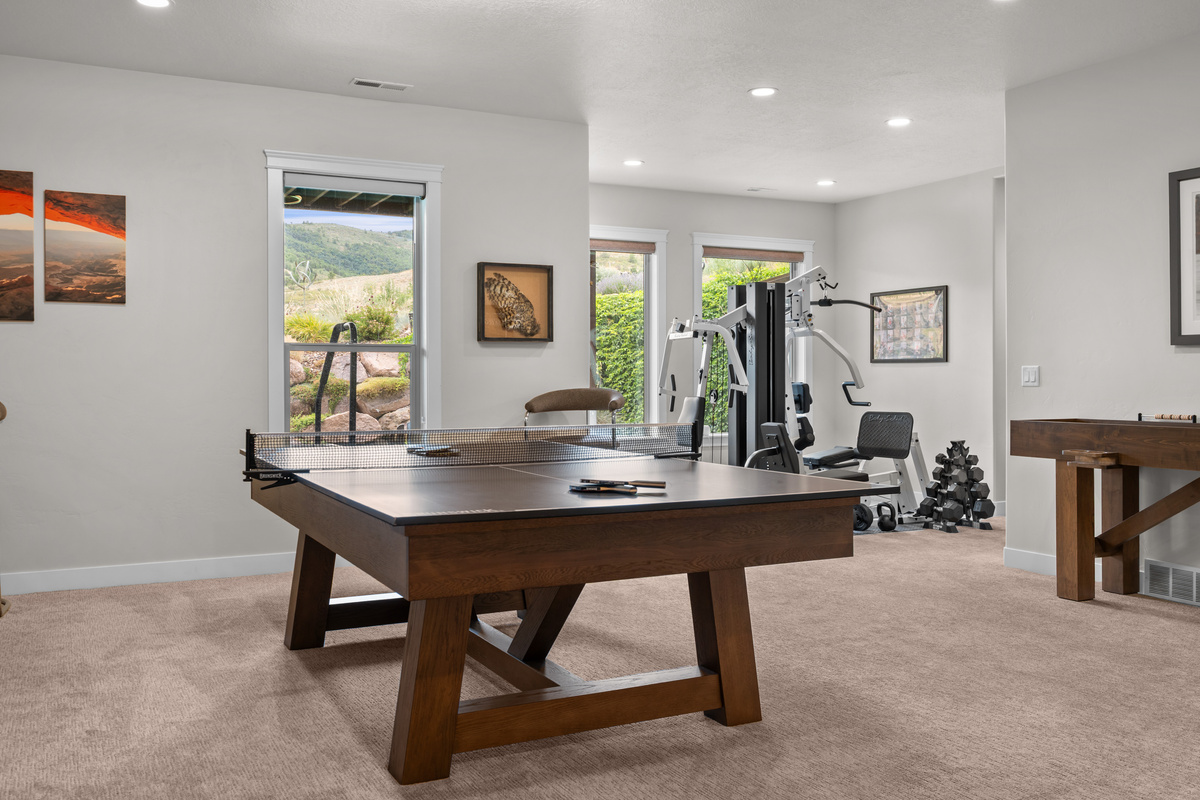 Spacious game room featuring ping pong, pool table, skeech, and plenty of room for family fun.
