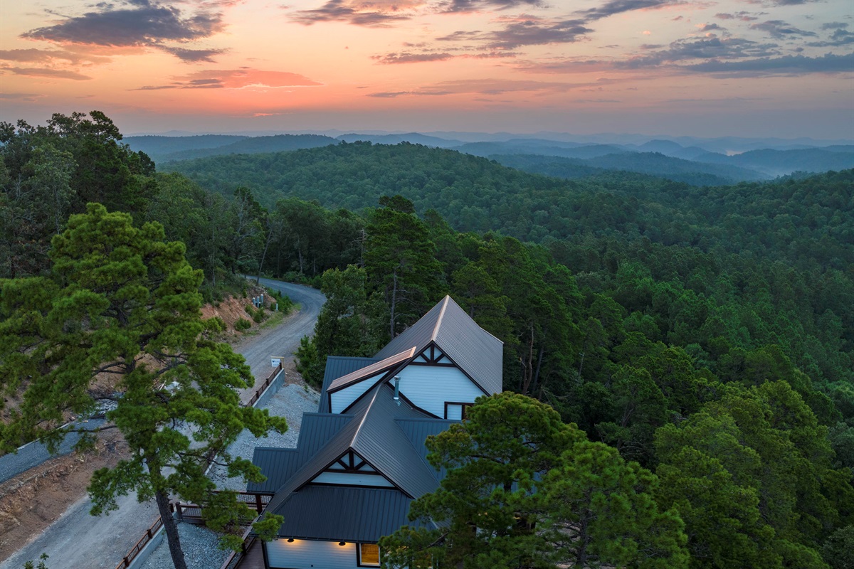 Aerial mountain view showcasing the cabin’s peaceful forest setting