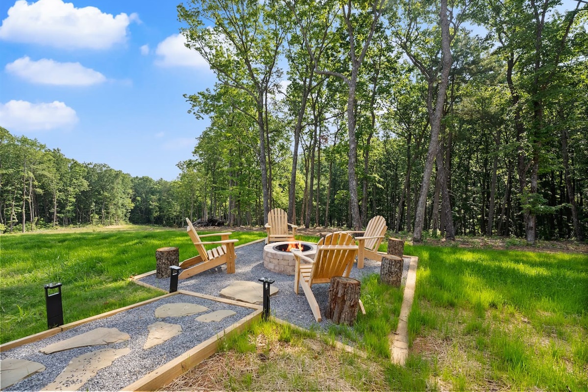 Enjoy peaceful moments or late-night laughs around the cozy fire pit, surrounded by Adirondack chairs and forest views.