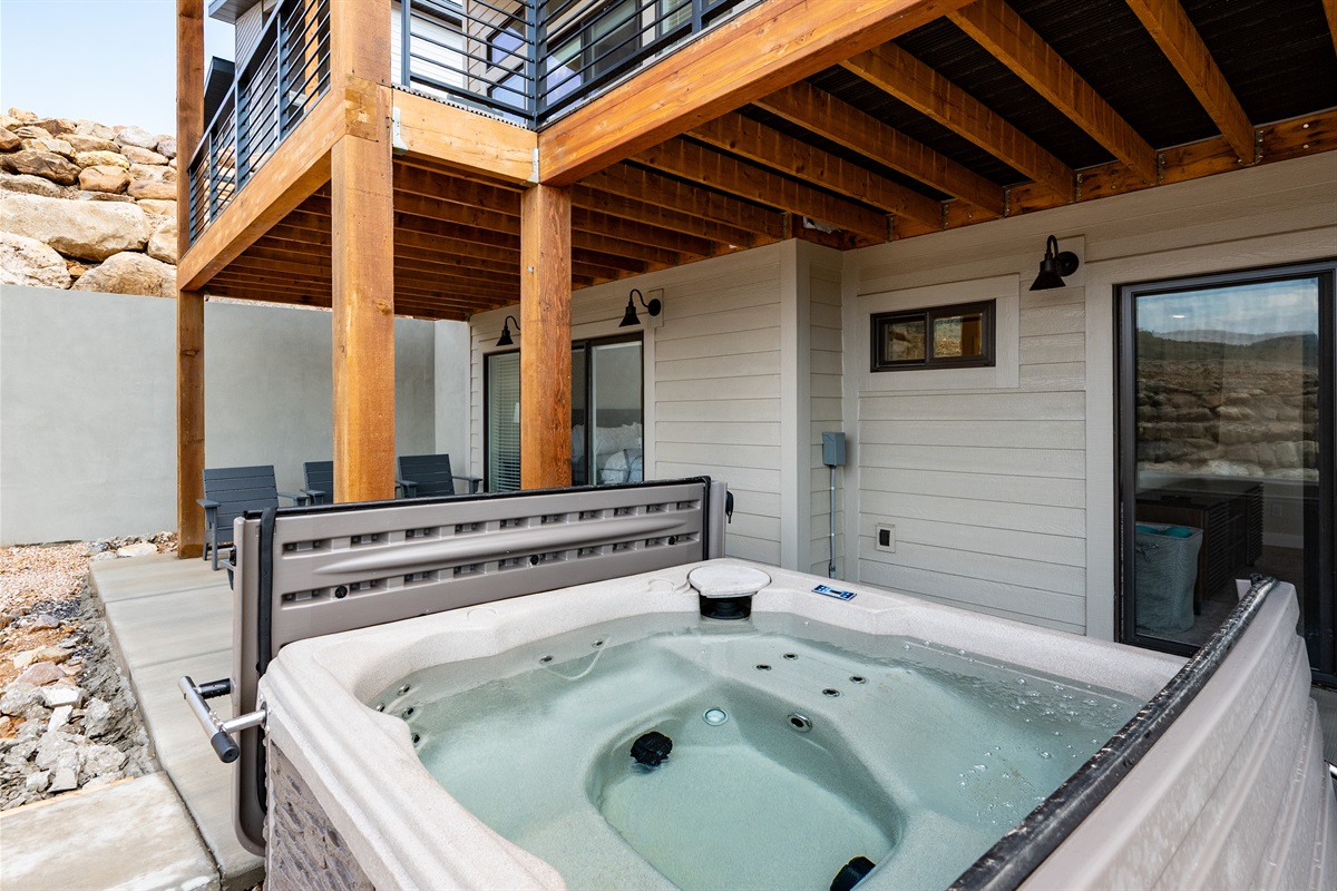 The hot tub is on the patio waiting for you.