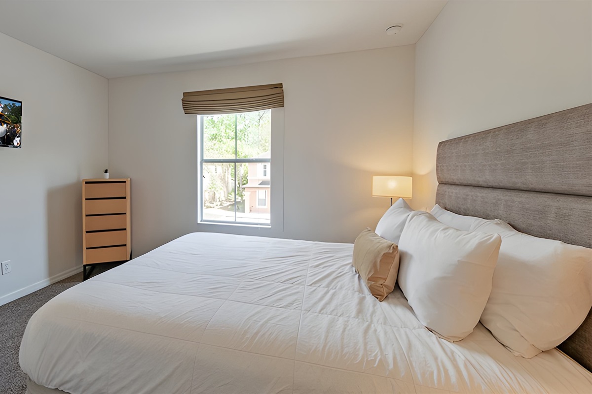 The third bedroom in the second floor, has a queen bed and a Smart TV.