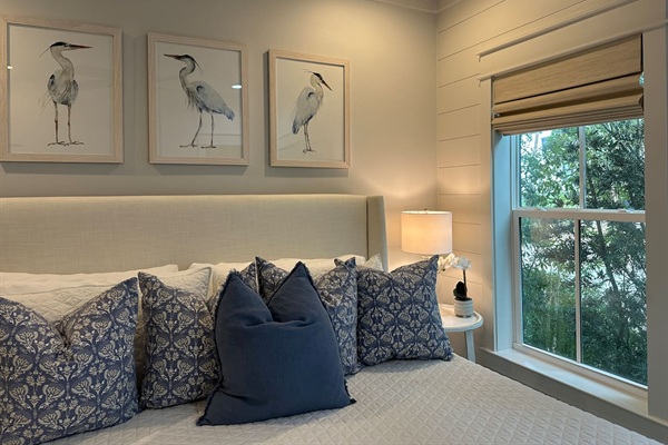 Spacious main level king bedroom suite with full ensuite bathroom, tiled shower and dual vanity sinks