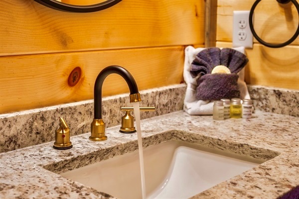 Plush towels neatly arranged alongside premium shampoo, conditioner, and body wash, providing a touch of luxury and comfort for your stay.