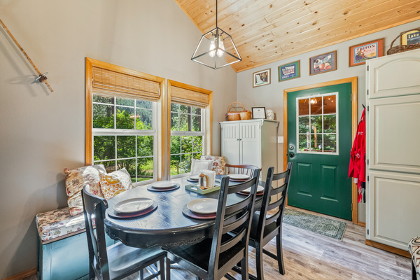 Dining room with window banquet seating and access to the back porch