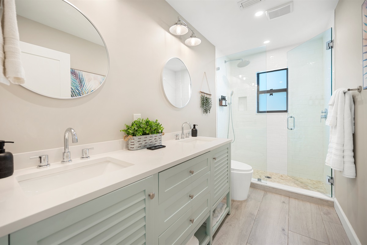 Guest Bath #2Coastal charm meets convenience with dual vanities and a pebble-floor walk-in shower. This bathroom is shared between Bedroom #2&3