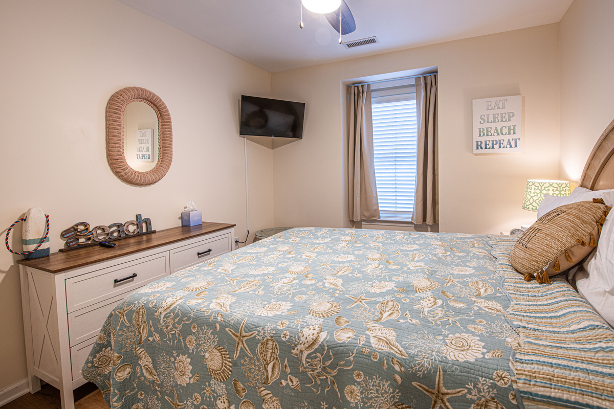 Bedroom 2 with White Dresser, and Wall-Mounted TV