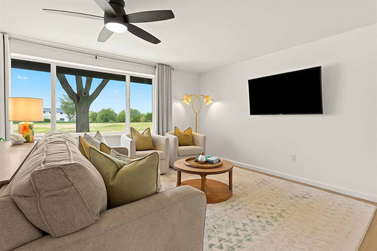 The open and airy living space is ideal for lounging with loved ones or enjoying a movie night after a day of exploring.