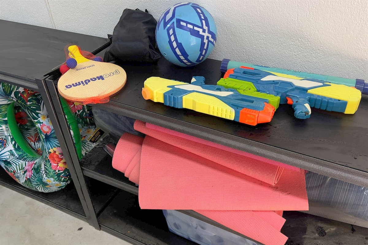 Pool and beach toys are located in the shared utility room. 