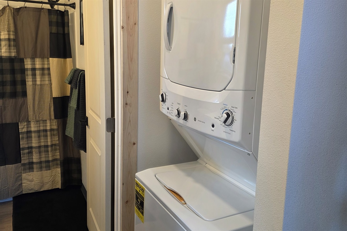 Stacked Washer/Dryer located just outside of the bathroom.