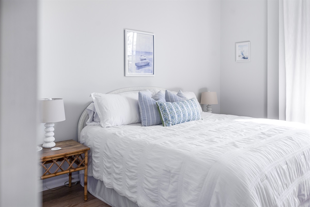 Relax in the serene comfort of the main bedroom, featuring plush bedding, peaceful views, and a private en-suite bathroom for added convenience and privacy.