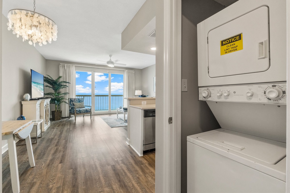 In-unit washer and dryer with a door for a quiet, comfortable stay, conveniently located in the hallway for easy access by all guests.