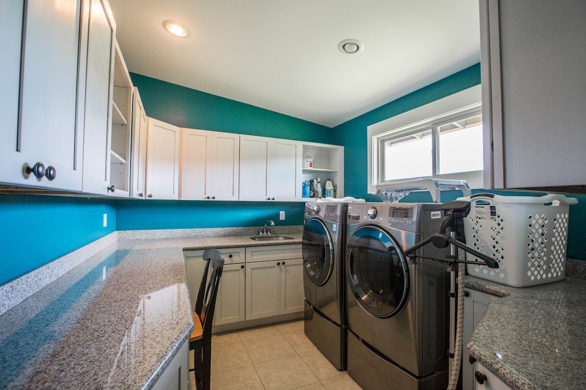 Large laundry room with state of the art washing machine and dryer.