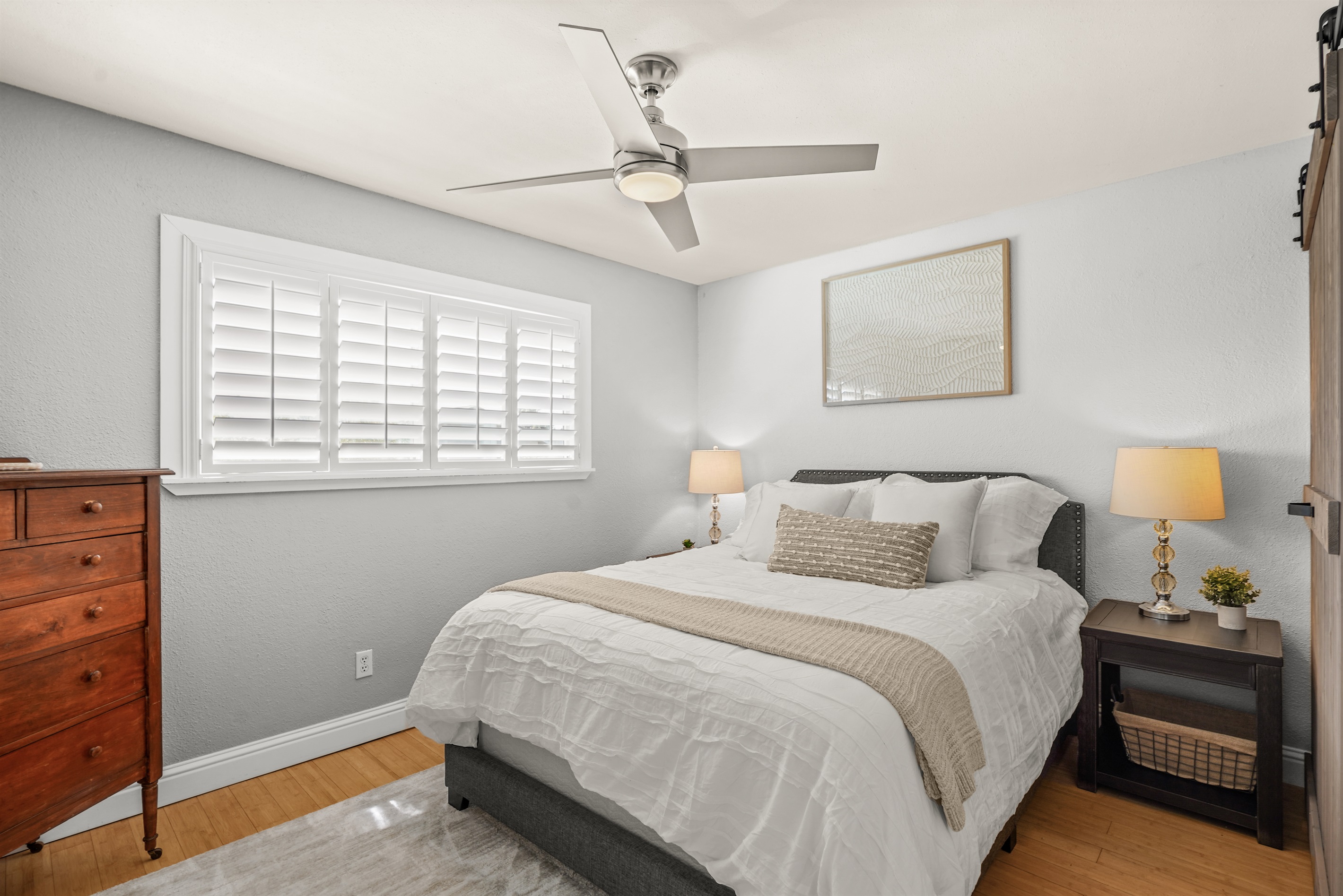 Bright upstairs bedroom featuring a queen bed and comfortable accommodations for guests.