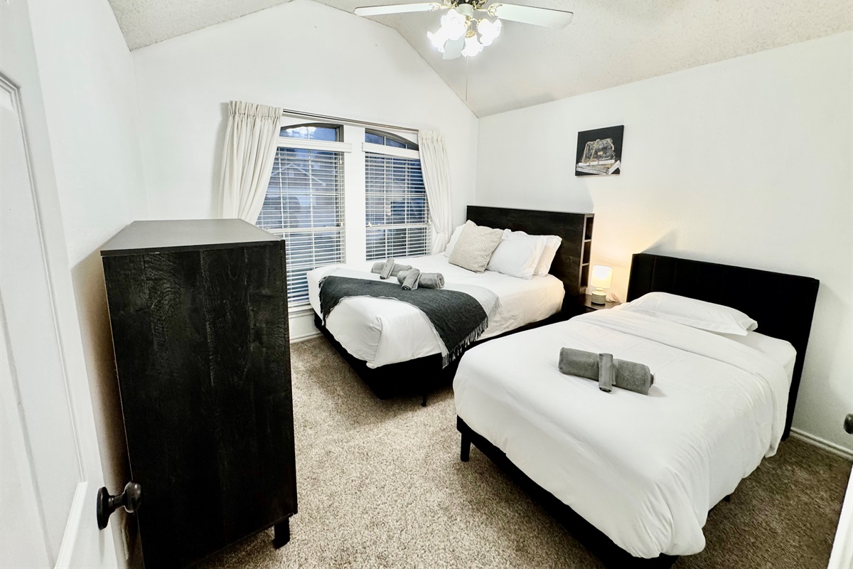 Cozy queen bed and single twin bed designed for comfort – perfect for couples or solo travelers.