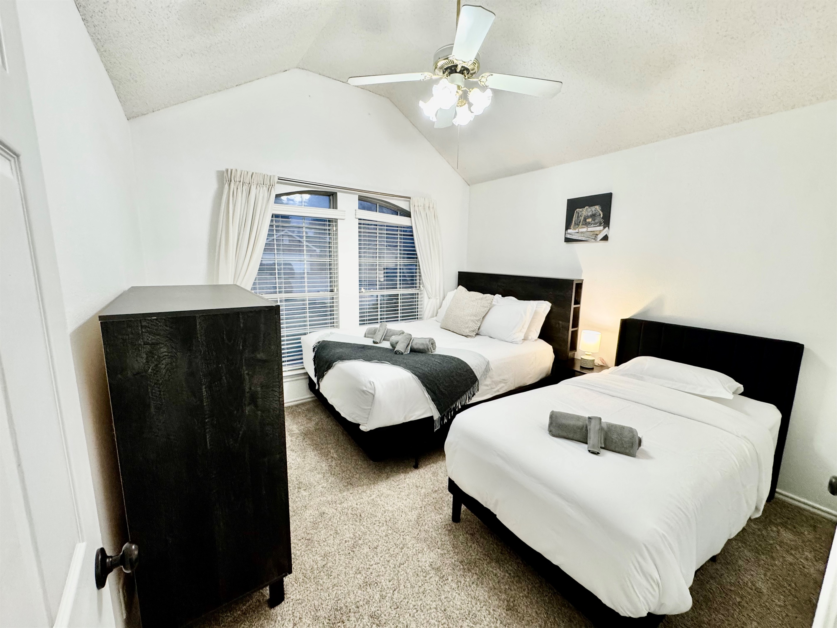 Cozy queen bed and single twin bed designed for comfort – perfect for couples or solo travelers.