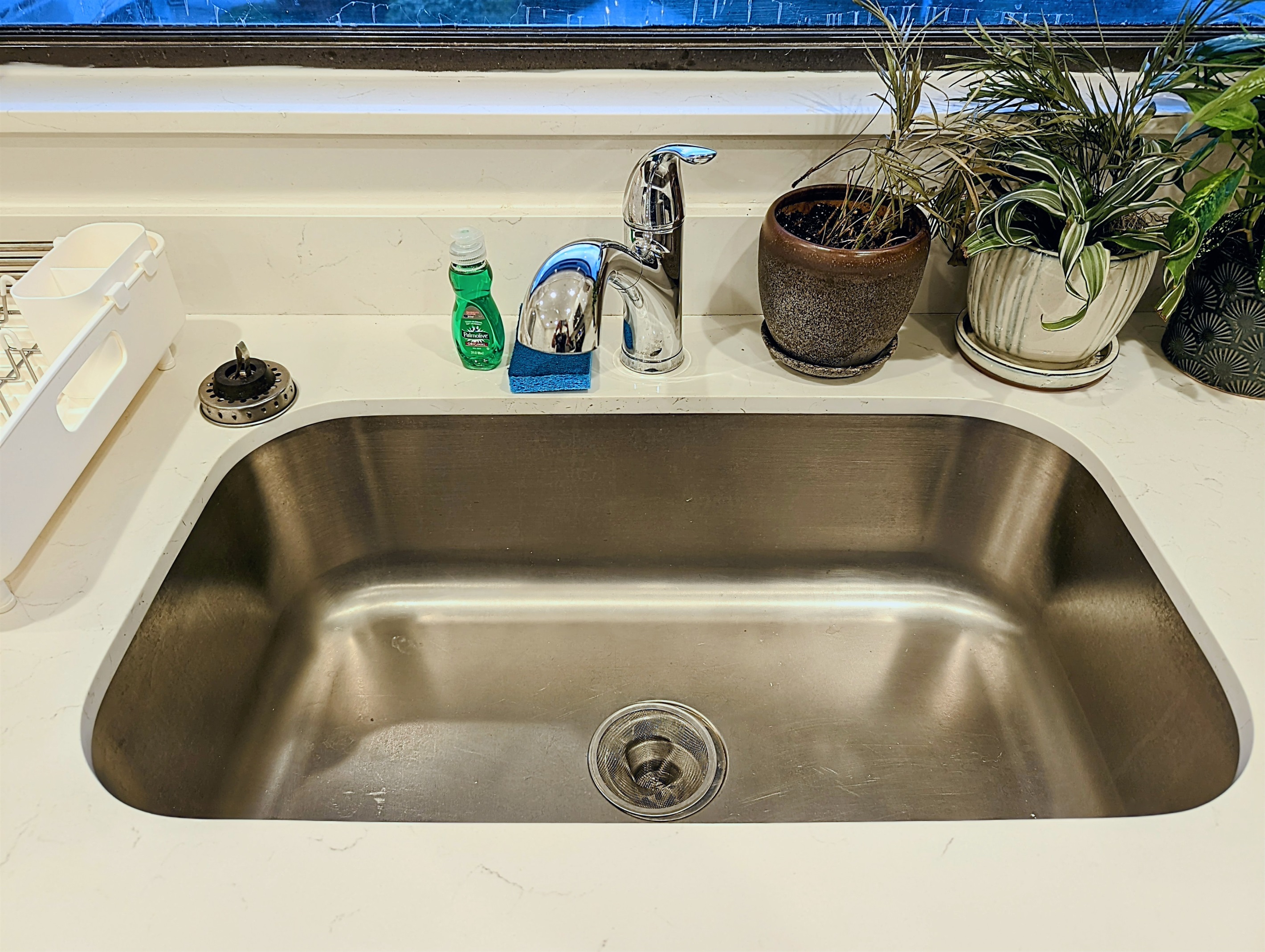 Deep stainless steel sink, which overlooks the center of Pier Walk's courtyard swimming pool.