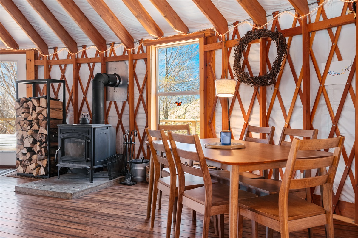 Cozy dining space nestled beside the wood-burning stove, offering the perfect spot for shared meals, morning coffee, and relaxing evenings inside the yurt.