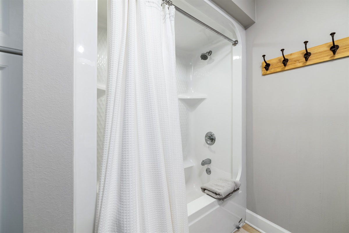 This well-lit bathroom offers ample space and essential amenities.  A clean and inviting retreat.