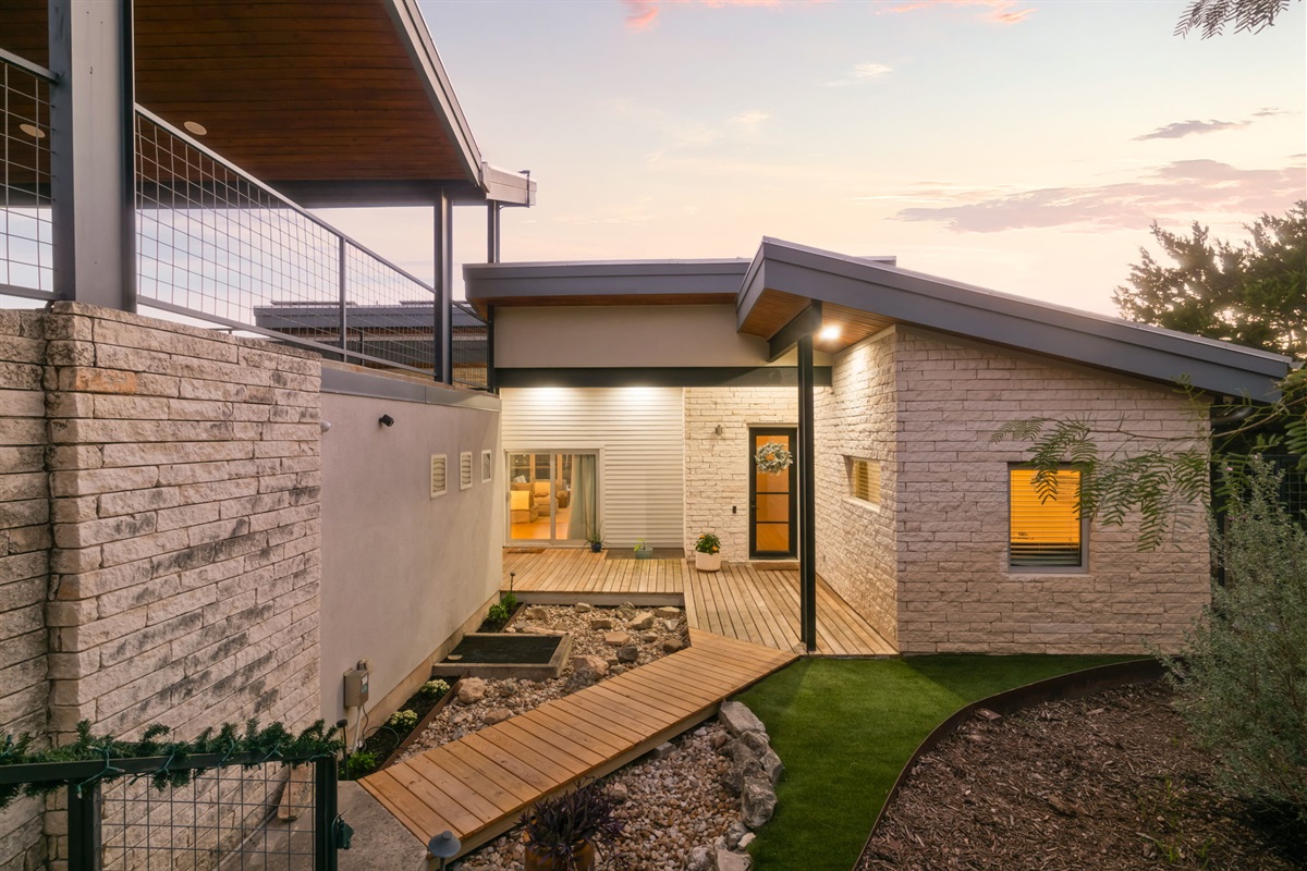 Inviting exterior entry with walkway and ambient lighting