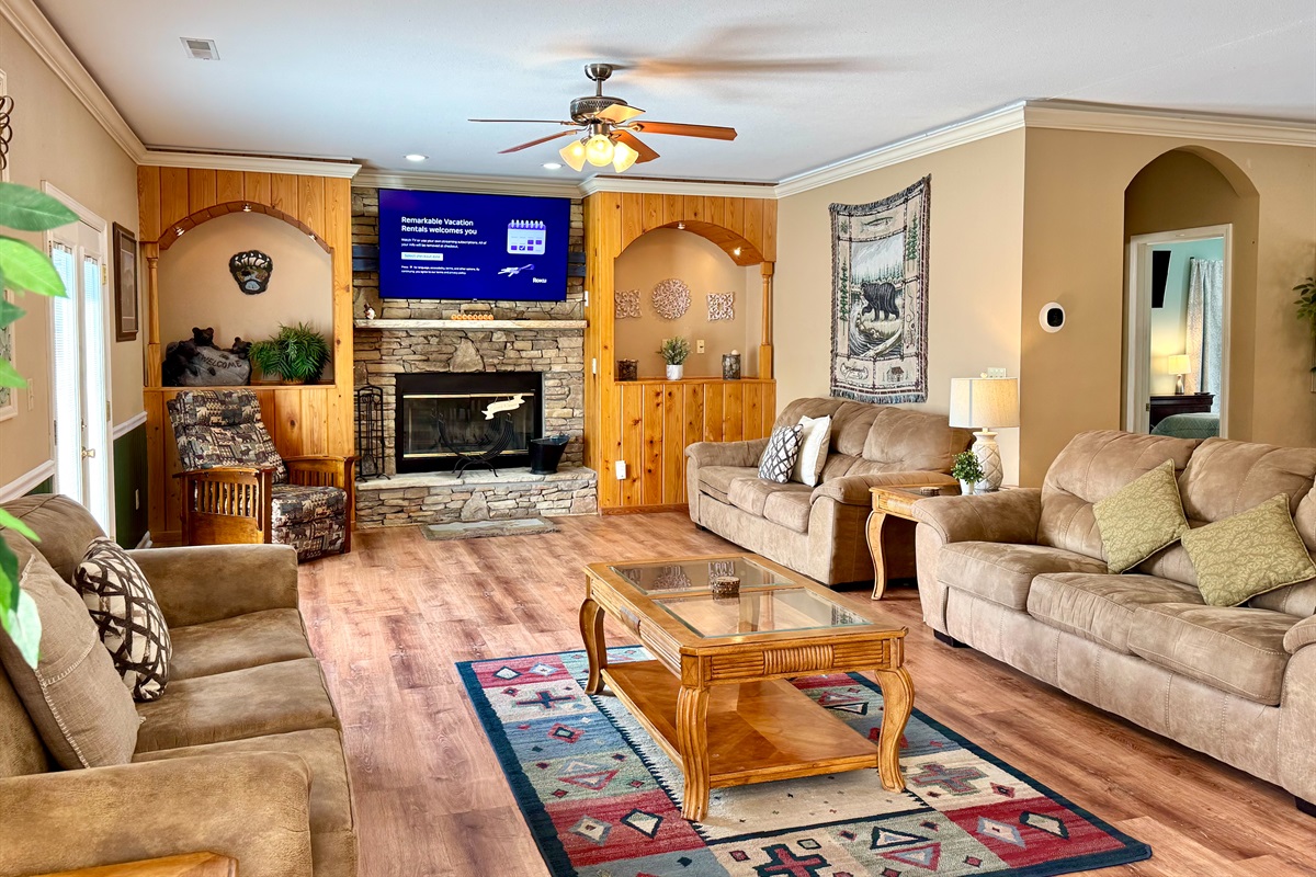 Stacked stone fireplace with a 65” TV and lots of seating