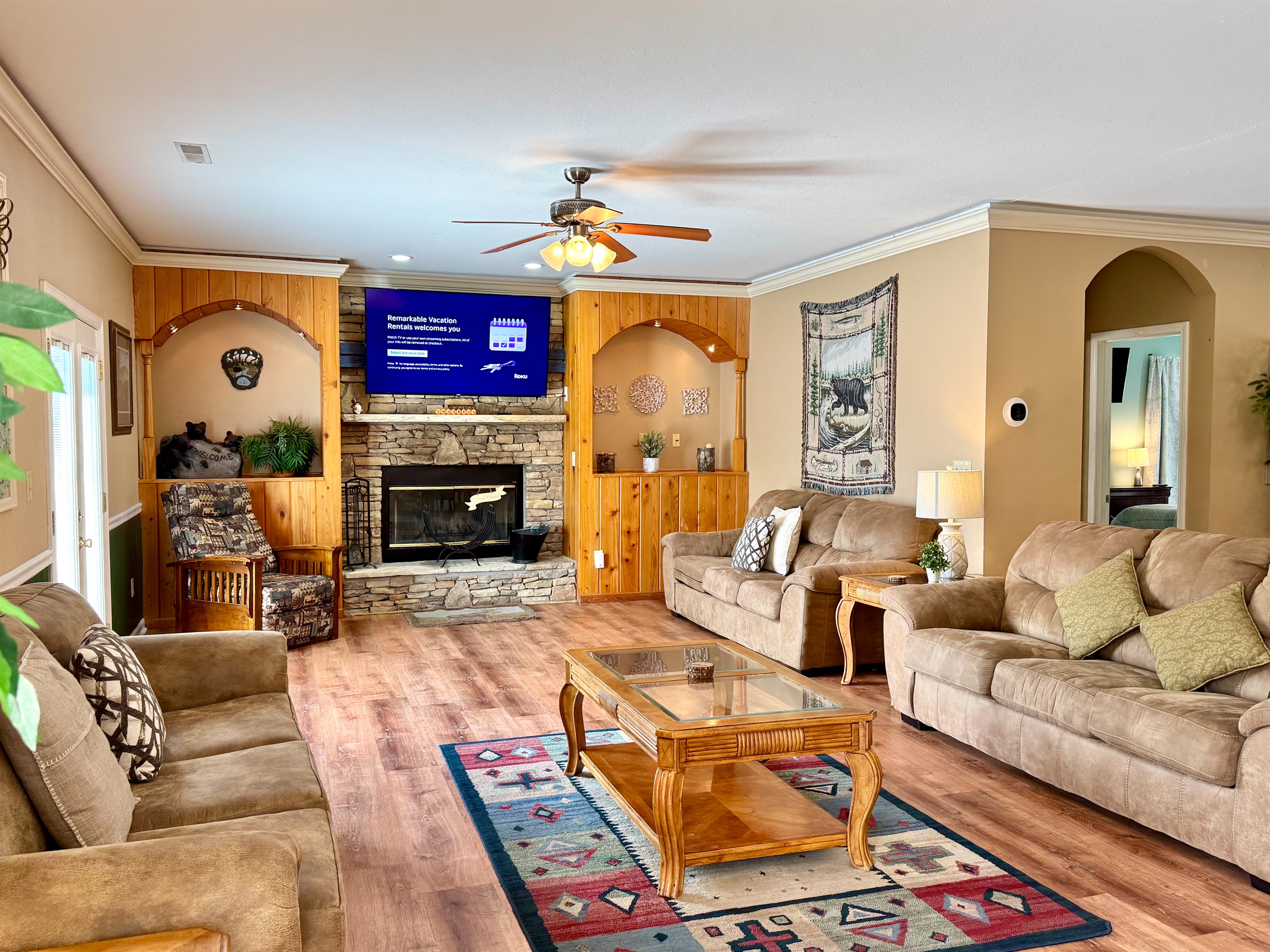 Stacked stone fireplace with a 65” TV and lots of seating