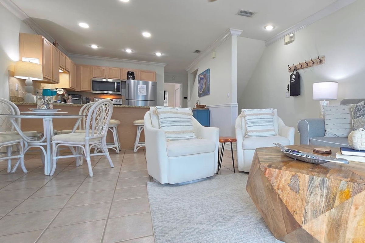 From every angle the main level invites you to settle in &mdash; seating arranged around the fireplace, dining table always ready when the group is.