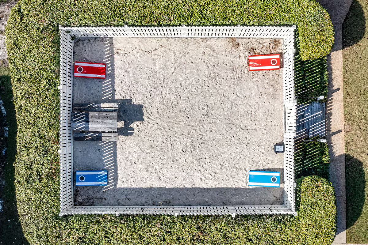 The sand area with cornhole