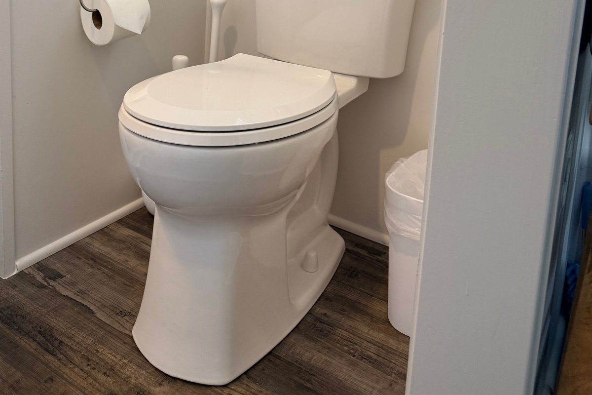 Nice size bathroom with shower, sink and residential toilet