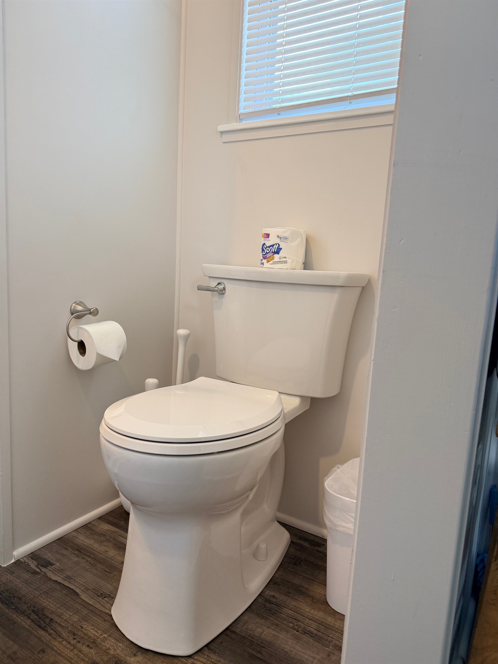 Nice size bathroom with shower, sink and residential toilet