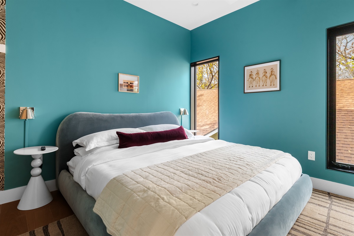 Cozy primary bedroom with a plush bed, calming colors, and natural light—designed for restful nights and relaxed mornings.