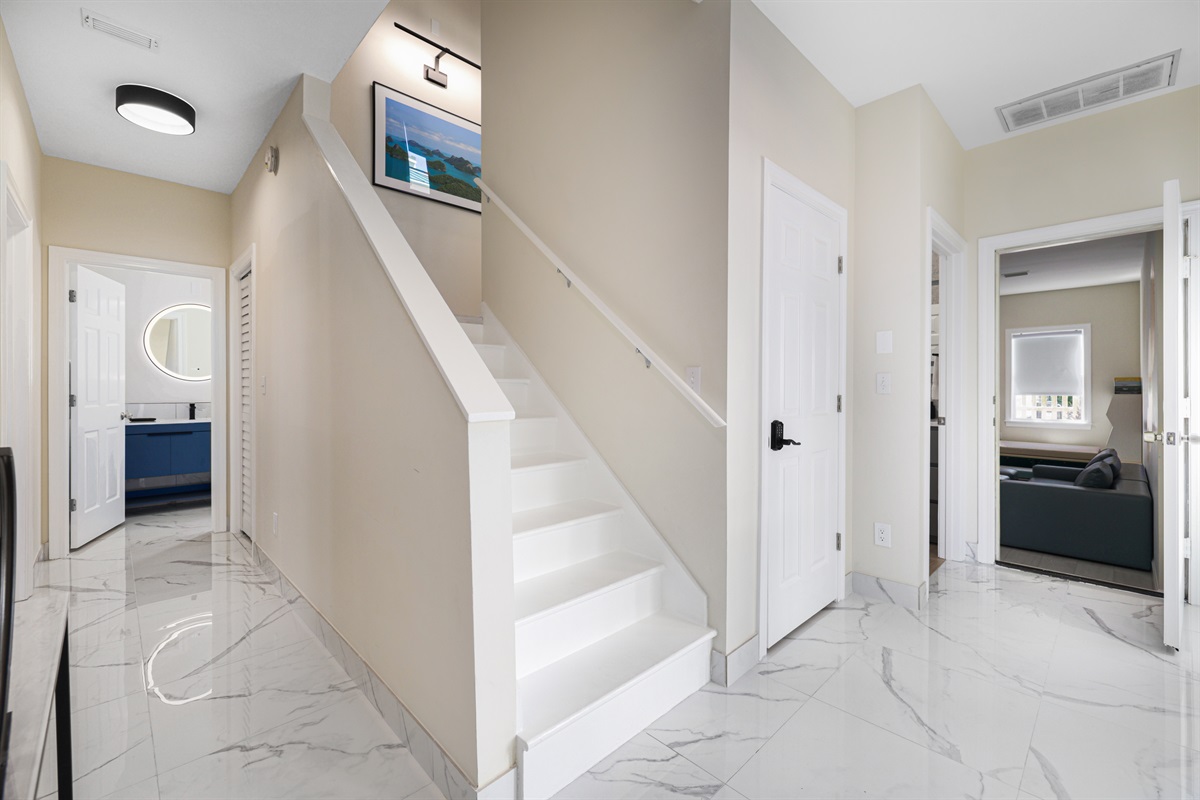 Entry Way for H2O Living - Hallway to Bedrooms 2 and 3 and to the Game Room/Bedroom 5, Steps to 2nd Level