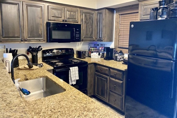 Fully stocked kitchen with breakfast bar and if you are looking to have a glass of wine on the deck no worries we have you covered with wine glasses too!