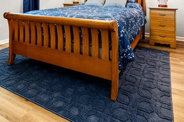 No Wake Queen Bedroom with Roku TV, a bookshelf, 2 nightstands, a dresser and two closet areas.