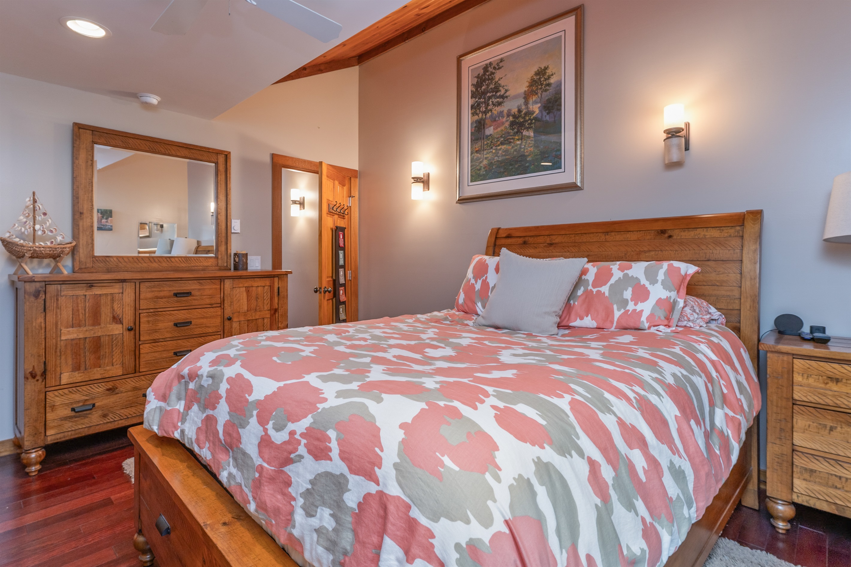 Cozy queen bedroom with warm lighting and nature views.