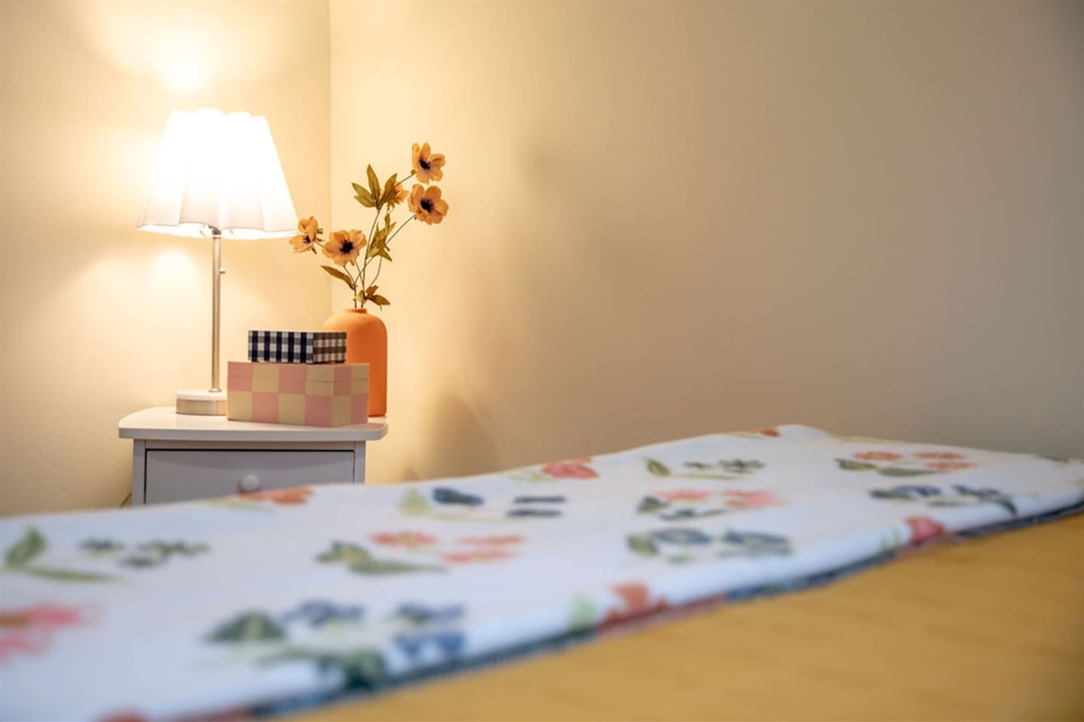 Comfortable queen-sized bedroom offering a restful retreat with ample space and natural light.