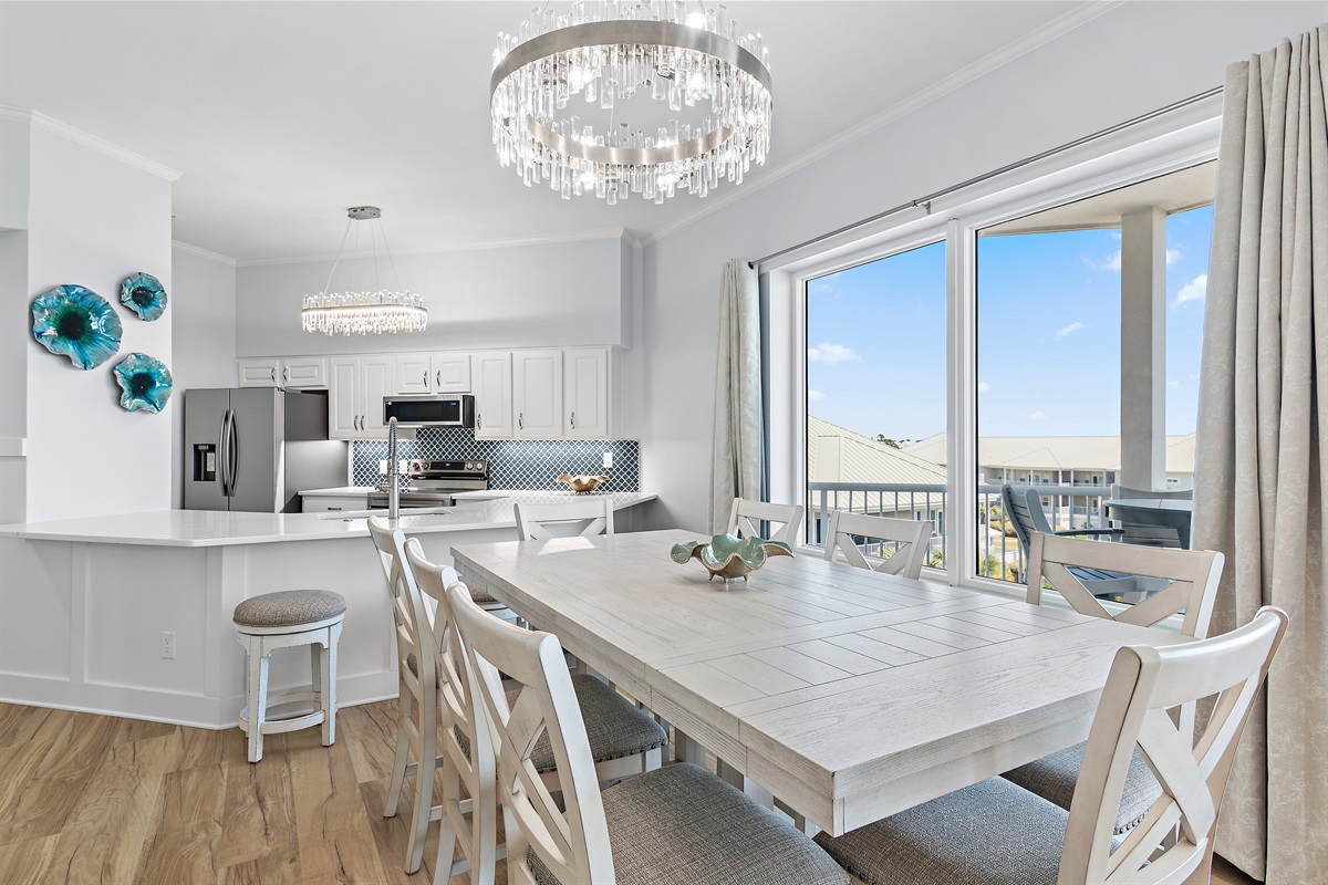 Gulf‑view dining area with elegant crystal chandelier