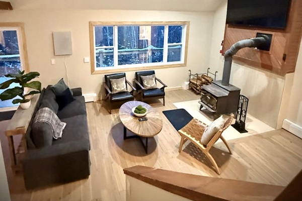 Spacious living room with a cozy woodstove