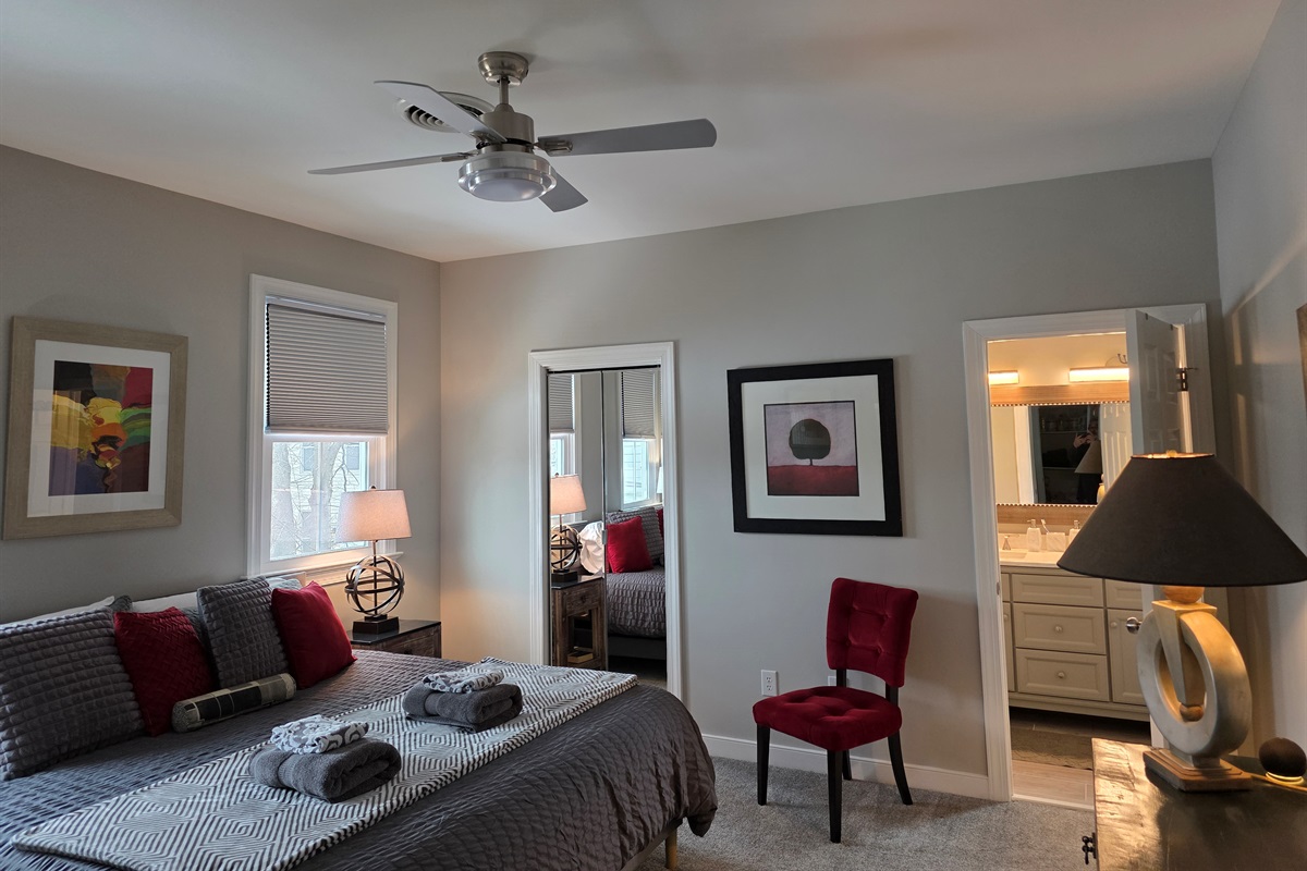 King Bedroom 1: Relax in style with bright light, plush bedding, and vibrant accents!