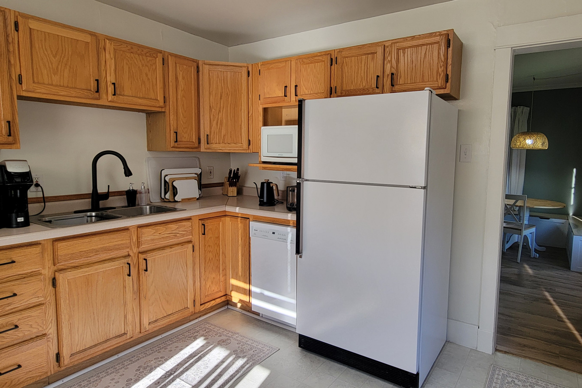 Kitchen with coffee maker, microwave, fridge, dishwasher, and the essentials for meals at home.