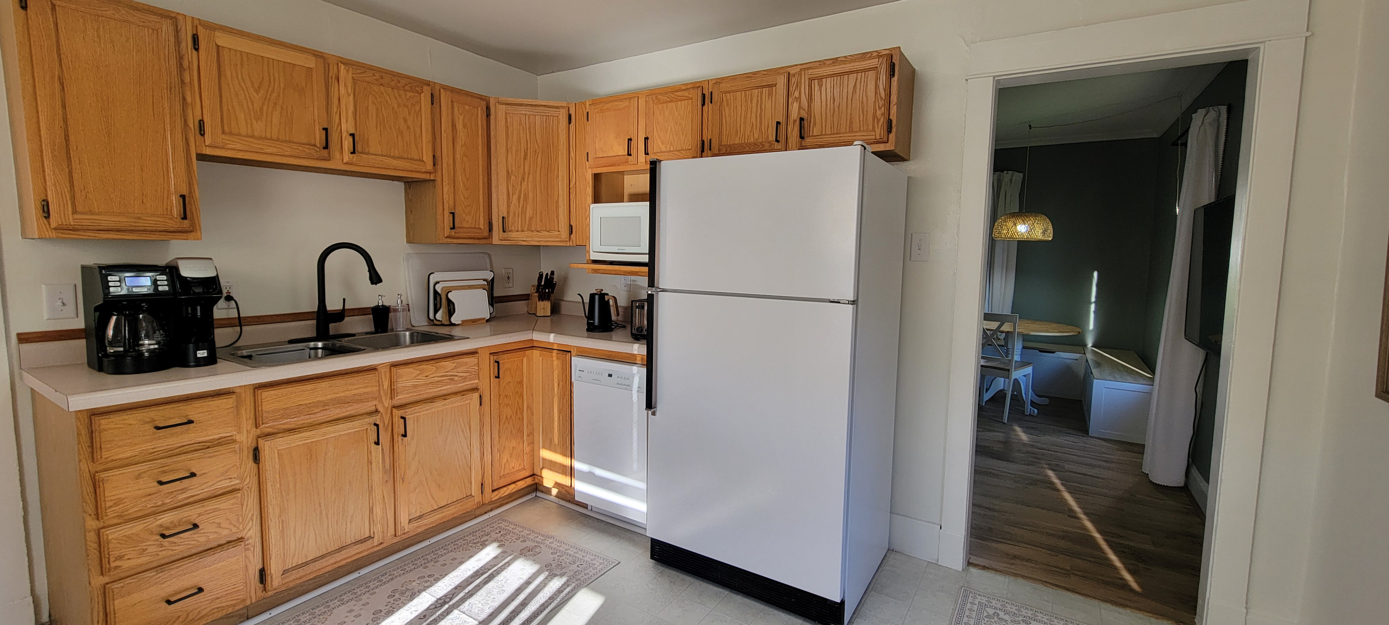 Kitchen with coffee maker, microwave, fridge, dishwasher, and the essentials for meals at home.