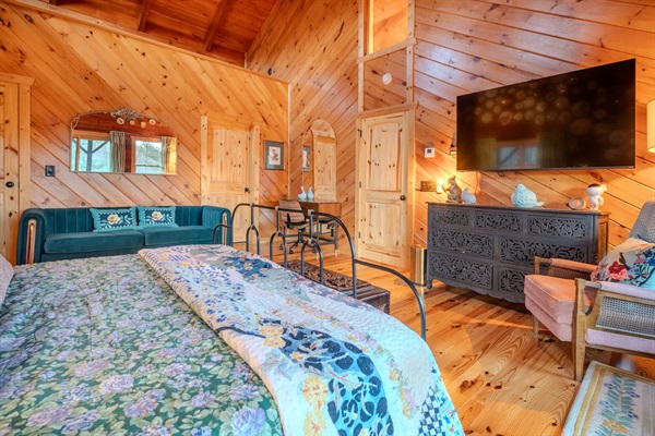 Porcelain room with comfy bed, sitting areas, en suite bath and porch walkout. 