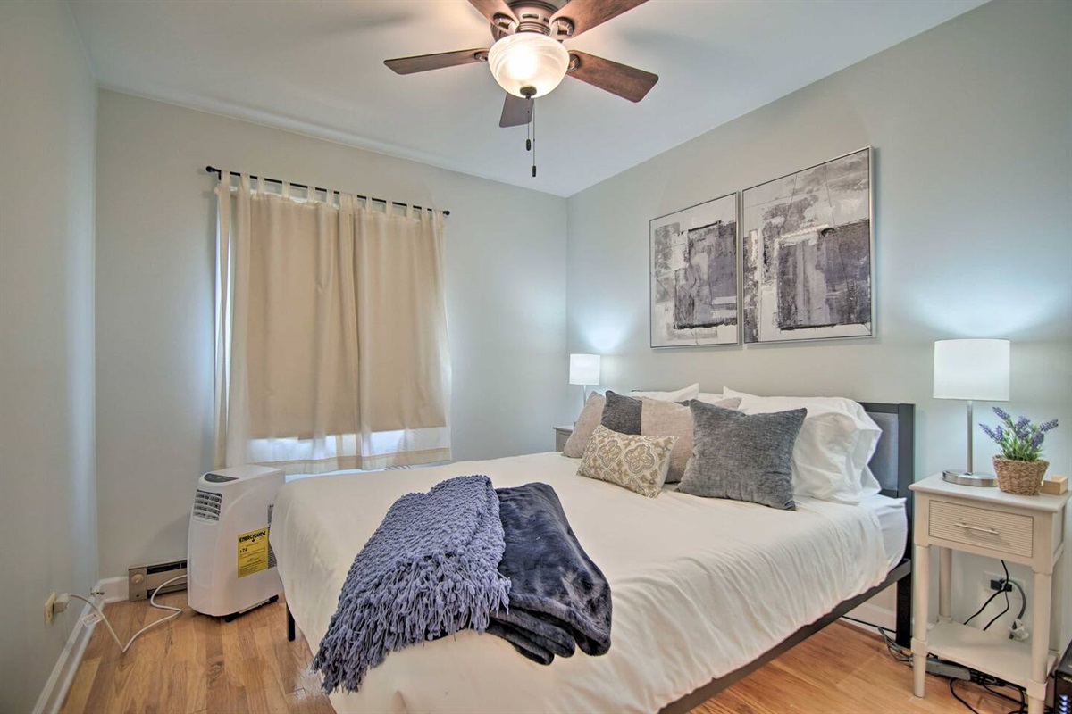 3Bd Unit:  The second upstairs bedroom has a queen-sized bed, window AC unit, and ceiling fan for your comfort and enjoyment.