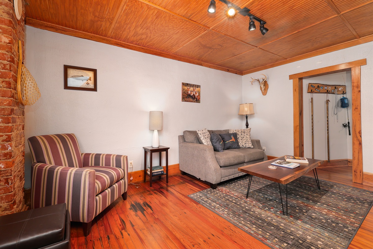 Living Room with couch, sitting area, bar stations and large TV