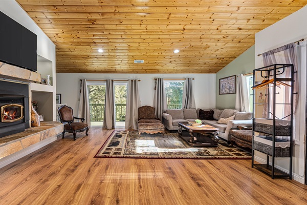 Large windows flood the living room with natural light and frame truly breathtaking views.