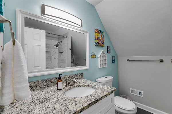 Spacious and stylish, this shared bath makes it easy for everyone to refresh and recharge.