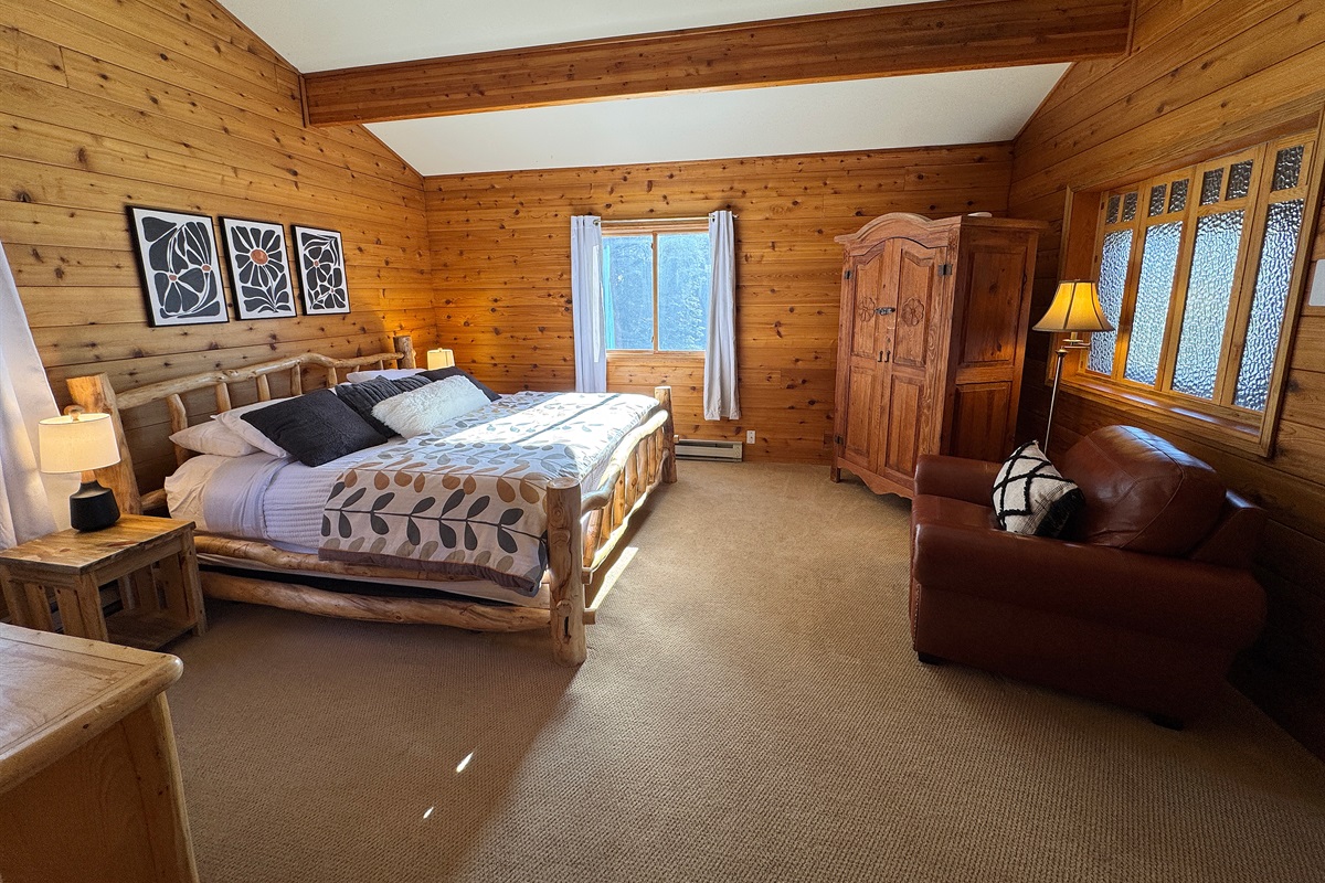 Primary bedroom with King bed, tv and seating